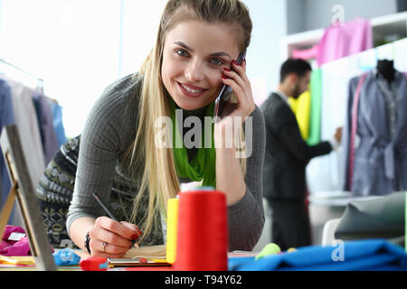 Custom Clothes Tailoring Service Designer on Phone Stock Photo