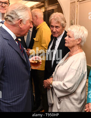 The Prince of Wales talks with Dame Judi Dench and her partner David Mills, at the annual Fortnum & Mason Food and Drink Awards at Fortnum & Mason, central London. Stock Photo