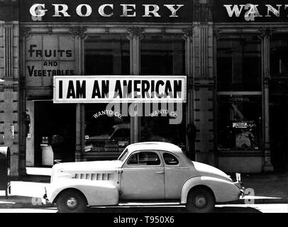 Entitled: 'A large sign reading 'I am an American' placed in the window of a store, at 13th and Franklin streets, on December 8, the day after Pearl Harbor. The store was closed following orders to persons of Japanese descent to evacuate from certain West Coast areas. The owner, a University of California graduate, will be housed with hundreds of evacuees in War Relocation Authority centers for the duration of the war. Stock Photo