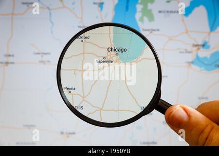 Chicago, United States. Political map. The city on the monitor screen through a magnifying glass in hand. Stock Photo
