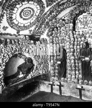 The Capuchin Crypt is a small space comprising several tiny chapels located beneath the church of Santa Maria della Concezione dei Cappuccini on the Via Veneto near Piazza Barberini in Rome, Italy. It contains the skeletal remains of 3,700 bodies believed to be Capuchin friars buried by their order. The Catholic order insists that the display is not meant to be macabre, but a silent reminder of the swift passage of life on Earth and our own mortality. Stock Photo