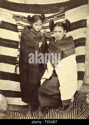 Hopi girls in traditional dress, taken by John K. Hillers (American, 1843 - 1925) in 1879. Albumen silver print. The Hopi are a Native American tribe, who primarily live on the Hopi Reservation in northeastern Arizona. According to the 2010 census, there were 19,327 Hopi in the United States. Stock Photo