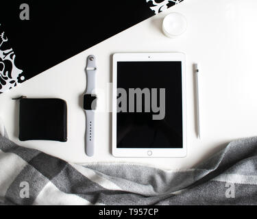 flat lay: Apple products on black and white background. Stock Photo