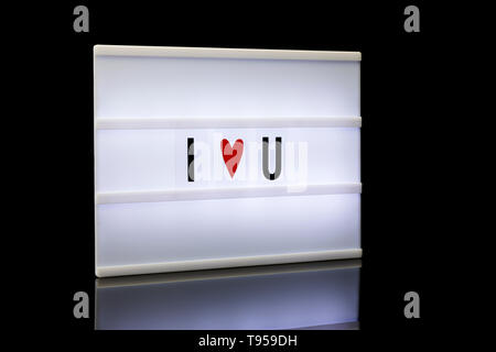 I love you, acronym written on lightbox reflected on black background Stock Photo