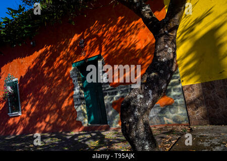 Brightly painted houses are seen on the street near the workshop of Laura Peña, a 67-years-old Salvadoran cigar maker, in Suchitoto, El Salvador. Stock Photo