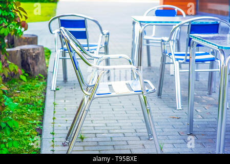 Empty chairs in outdoor cafe or restaurant on summer day Stock Photo