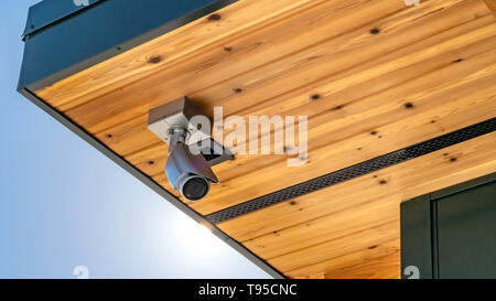 Panorama Home with security camera installed on the wooden underside of its roof Stock Photo