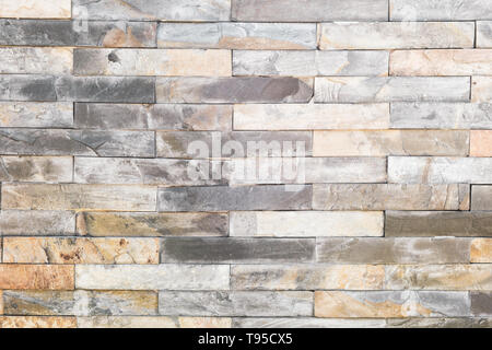 brick wall , texture of multi colored stone blocks closeup Stock Photo