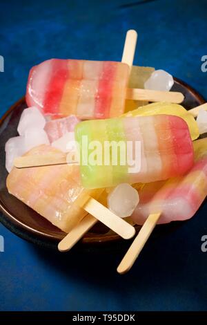 Popsicles on a blue table. Stock Photo