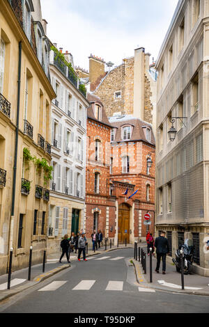 Paris, France - 24.04.2019: Old street in Paris, France. Cozy cityscape of Paris. Architecture and landmarks of Paris.