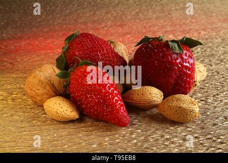 mix the collection of dried fruit and strawberries on yellow and red light Stock Photo