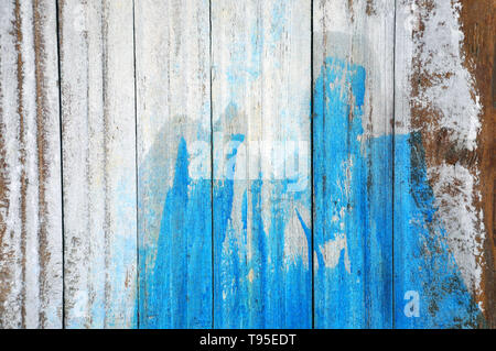 Old white wall of planks painted blue. Stock Photo