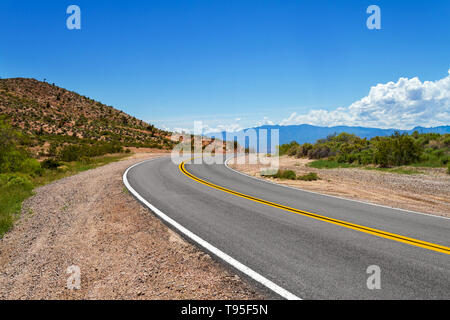 Curved road in the desert in Southern Nevada Stock Photo