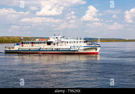 Samara, Russia - May 11, 2019: River cruise ship with passengers sailing on the Volga River in summer sunny day Stock Photo