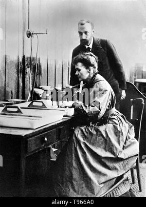 Marie and Pierre Curie in their laboratory in Paris. Pierre Curie was introduced to Maria Sklodowska by a friend and took Maria into his laboratory as his student. He began to regard her as his muse. She refused his initial proposal, but finally agreed to marry him on July 26, 1895. Marie Curie (November 7, 1867 - July 4, 1934) was a Polish-French physicist and chemist. Stock Photo