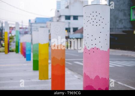 Colorful pillars on a sidewalk Stock Photo