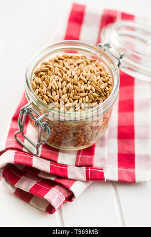 Healthy spelt grains in jar. Stock Photo