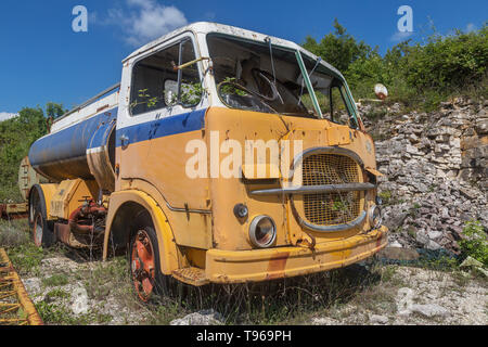 old yellow abandoned industrial truck Stock Photo