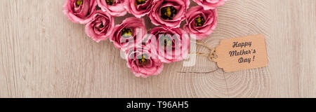 panoramic shot of pink eustoma flowers and paper label with happy mothers day words on wooden table Stock Photo