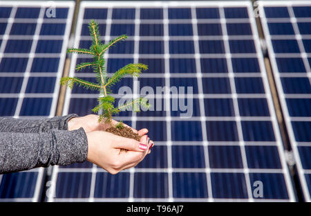 Saving nature by using green solar energy concept. And accidentally also funny optical illusion concept, dots flickering, changing places on the backg Stock Photo