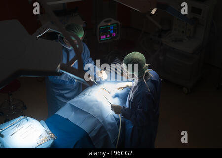 Asian doctor and an assistant in the operating room for surgical venous vascular surgery clinic in hospital. Stock Photo