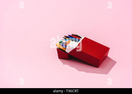 crayons in cigarette box colorful crayons in cigarette pack on pink with copy space, smoking concept  Stock Photo