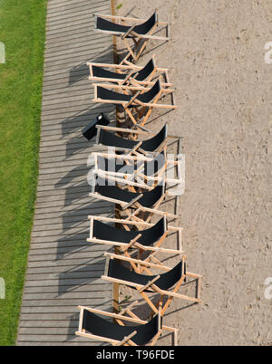 Sun loungers are placed on the lawn waiting for idle people Stock Photo