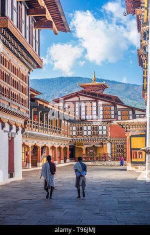 Two monks strolling in the courtyard of Rinpung Dzong, also known as Paro Dzong, Bhutan Stock Photo