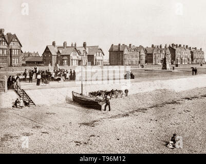 A late 19th Century view of a small sailing boat, donkeys and toursts on the beach at Lytham St Annes aka St Annes-On-Sea, a seaside resort on the Fylde coast of Lancashire, England, south of Blackpool on the Ribble Estuary.  On 14 October 1874 the St Anne's-on-the-Sea Land and Building Company Ltd was registered, mainly at the instigation of Elijah Hargreaves, a wealthy Lancashire mill owner from Rawtenstall to develop the area as a resort for people from Lytham and Southport. Stock Photo