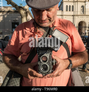 Man using a twin-reflex analog camera Stock Photo