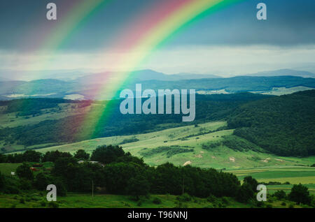 double rainbow over hills in rural landscape in Romania, Eastern Europe Stock Photo