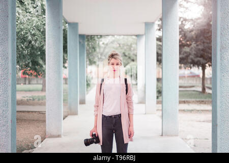 Young woman with camera portrait Stock Photo