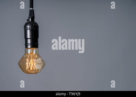 Retro light bulb on grey background Stock Photo