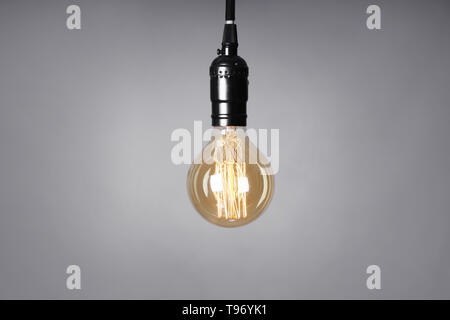 Retro light bulb on grey background Stock Photo