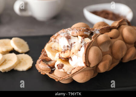 Delicious sweet bubble waffle on plate, closeup Stock Photo