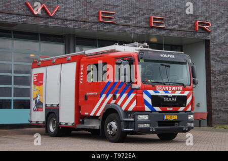 Almere, The Netherlands - May 19, 2016: Dutch fire engine standing in font of a fire station. Stock Photo