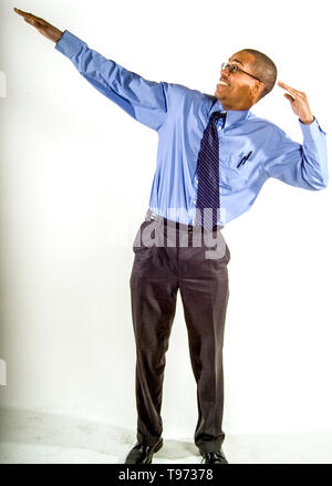 An African American railroad utility office worker poses exuberantly at the Los Angeles train yard. Stock Photo