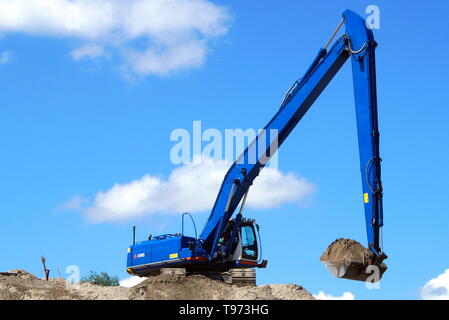 Almere Stad, Flevoland, The Netherlands - June 8, 2015: Hitachi Crawler Excavator working at a sandy Dutch construction site.