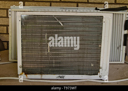 Window air conditioner sitting on patio table Stock Photo
