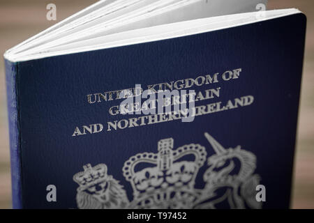 Stock Image: New issue blue and gold British passport of the United Kingdom of Great Britain and Northern Ireland. Stock Photo