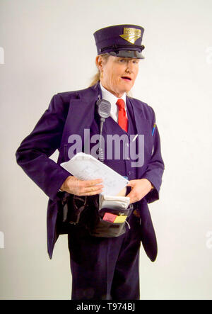 A friendly uniformed woman railroad conductor poses with her equipment at the Los Angeles train yards. Stock Photo