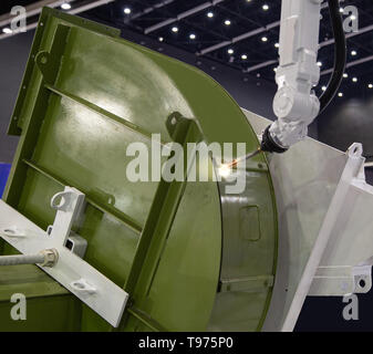 Robotic welding arm welding large ventilation blower Stock Photo