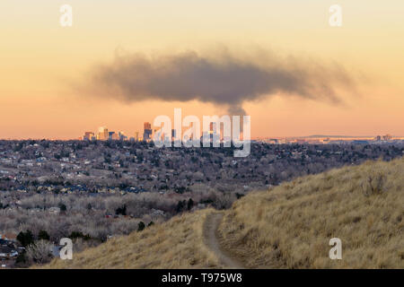 Smoke Cloud Hovering Over Downtown Denver - A huge thick cloud of black smoke hovering over the city's evening skyline, Colorado, USA. Stock Photo