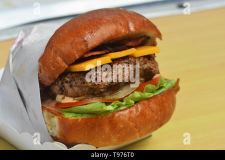 Fresh tasty burger  on wooden table Stock Photo