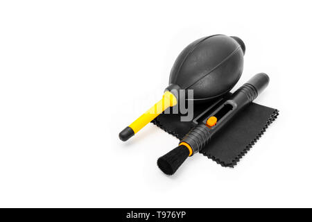 Camera Cleaning Set Isolated on White Studio Background with Clipping Path. Closeup Used Lens Cleaning Wipes (Microfiber Cloth), Blower Brush and Lens Stock Photo