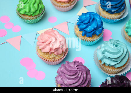 Different cupcakes on color background Stock Photo