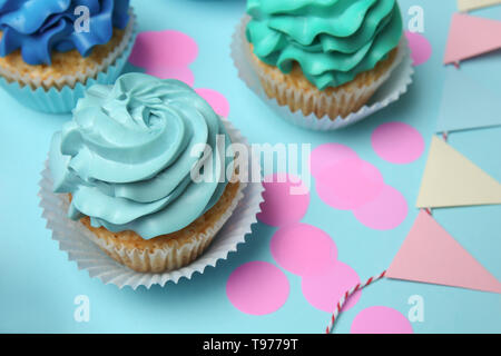 Different cupcakes on color background Stock Photo