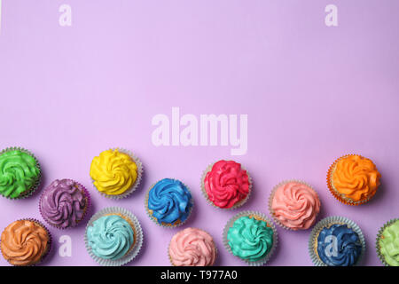 Different cupcakes on color background Stock Photo