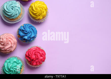 Different cupcakes on color background Stock Photo