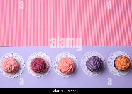Different cupcakes on color background Stock Photo
